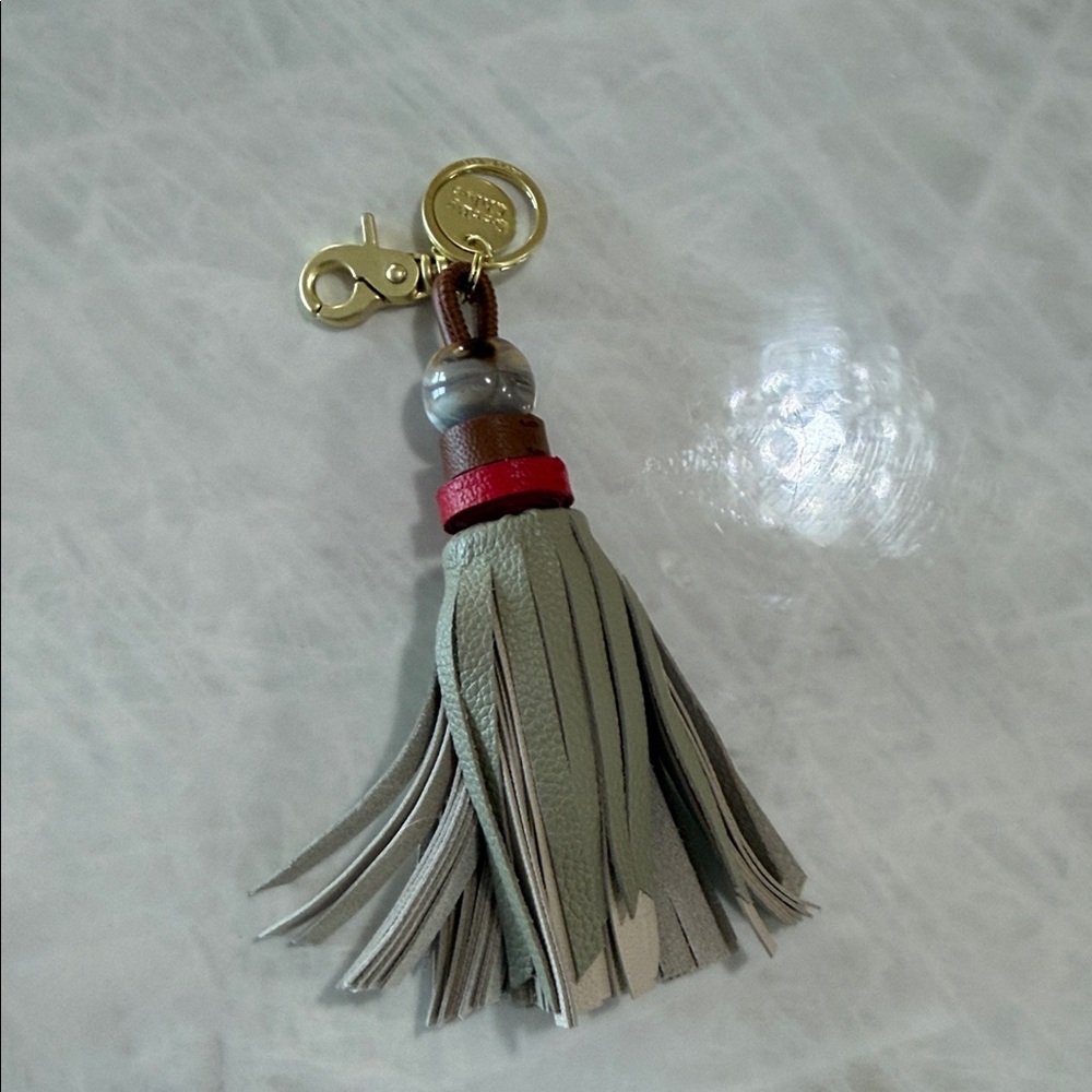See By Chloe Gray and Red Tassel Keychain